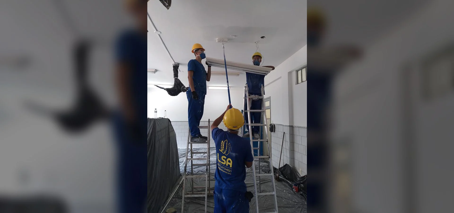 Equipe e serviço da LSA em atividade de pintura interna comercial.
